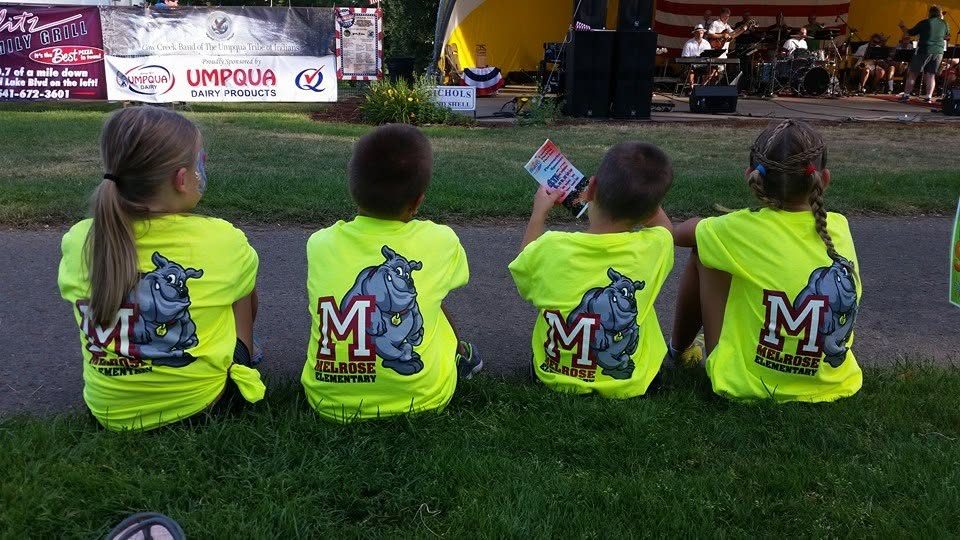 Students in Melrose Bulldogs shirts watching an outdoor event
