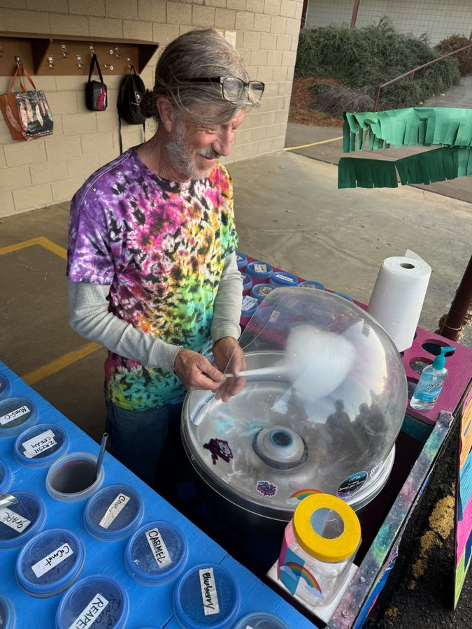 A volunteer making cotton candy