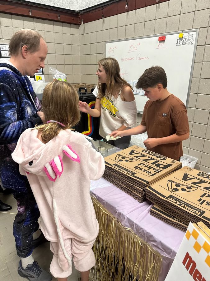 Volunteers serving pizza at a school event